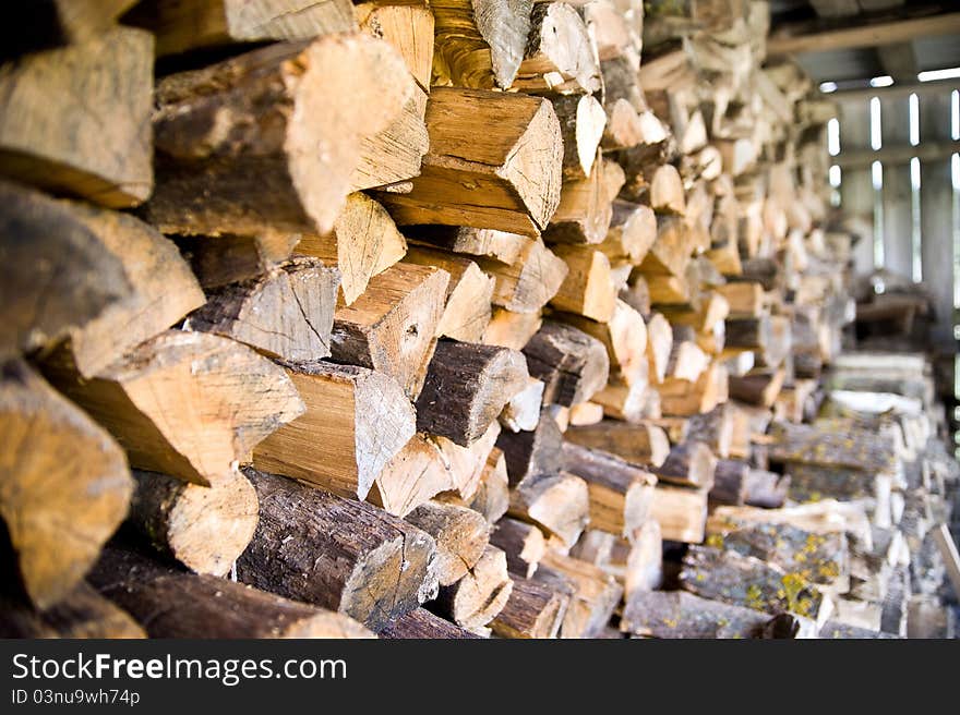 Firewood stock of a round tree trunks