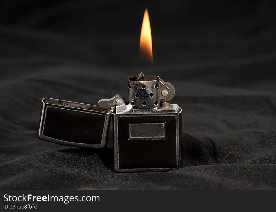 Open flame lighter on black background. Open flame lighter on black background