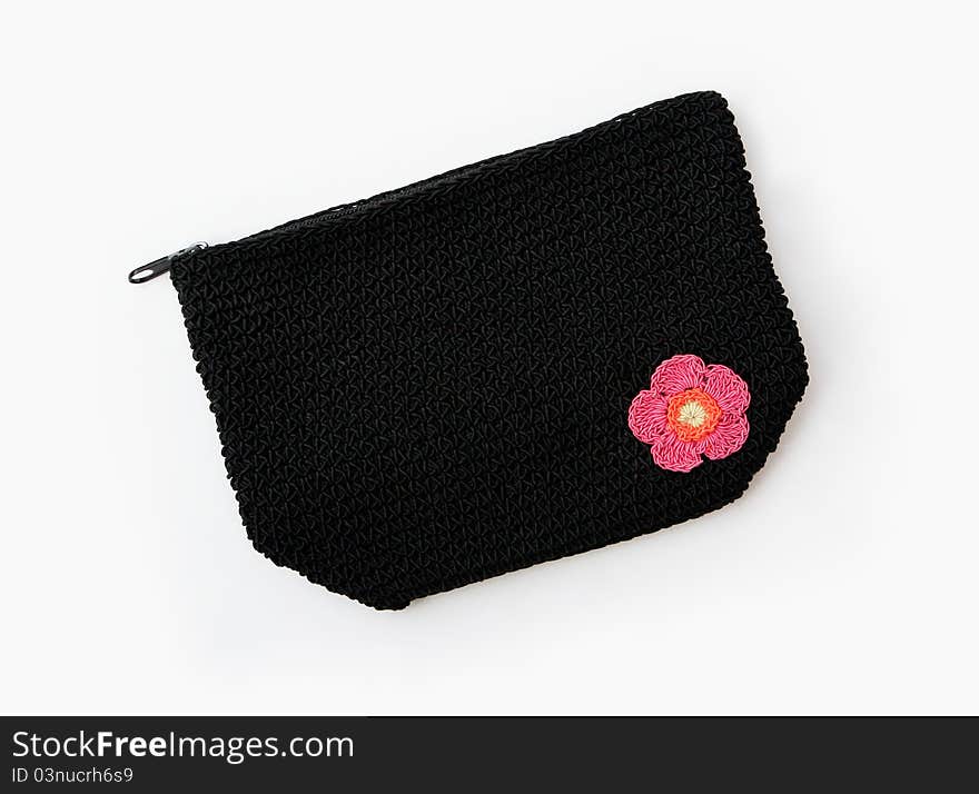 Black Knit Makeup or Accessory Bag with Embroidered Flower isolated on white background