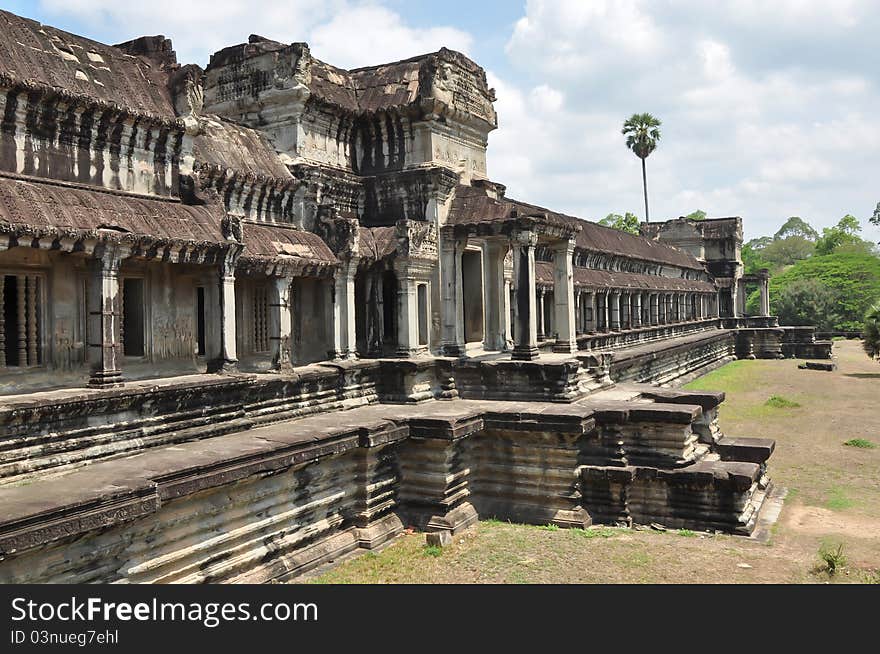 An ancient Khmer building in the territory of Angkor Wat, Cambodia, severely damaged earlier and reconstructed later.