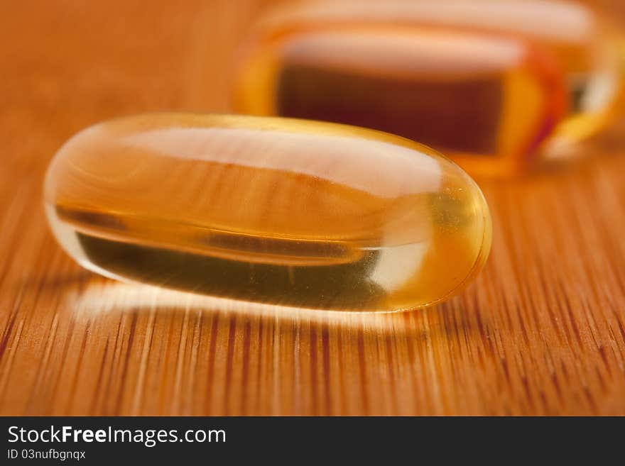 Medical pill against diseases on a wooden table.