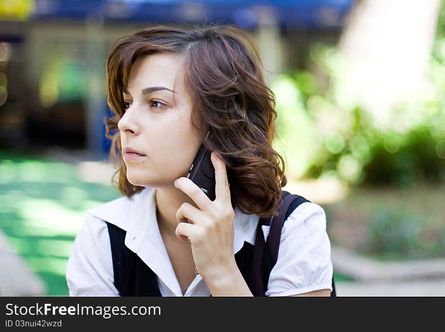 Young woman is speaking on her cell-phohe. Young woman is speaking on her cell-phohe