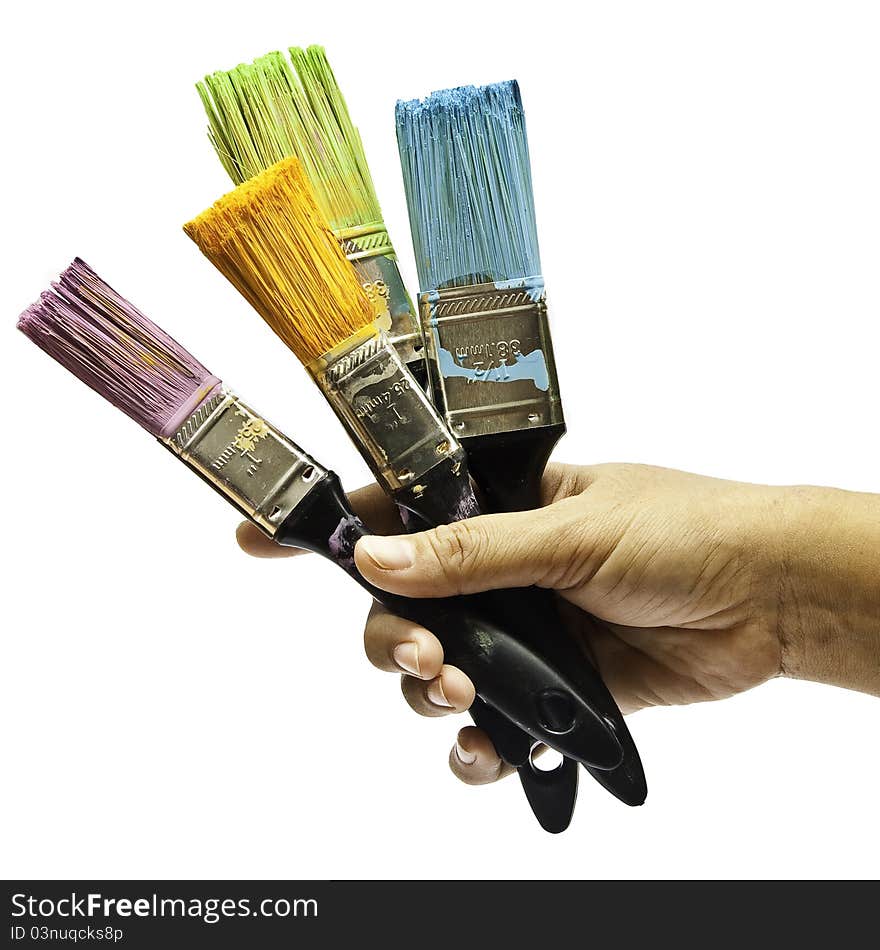 The hand of artist holding four of brushes on isolated white background. The hand of artist holding four of brushes on isolated white background