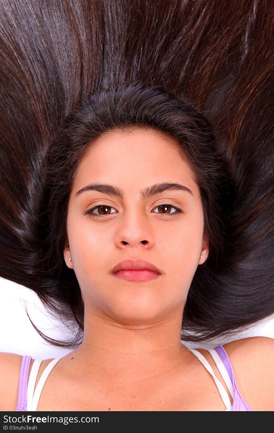 Young woman with dark brown long hair looking at camera. Young woman with dark brown long hair looking at camera