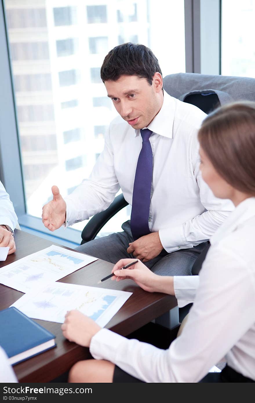 Businessman is in discussion with the staff in the office. Businessman is in discussion with the staff in the office