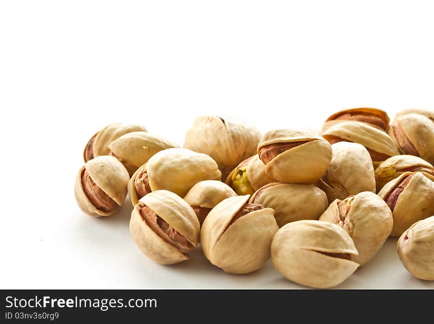 Pile of pistachios is on a white background