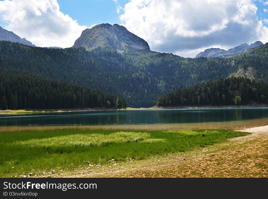 The landscape showing an amazing nature of Durmitor mountine and Black lake in Montenegro. The landscape showing an amazing nature of Durmitor mountine and Black lake in Montenegro.