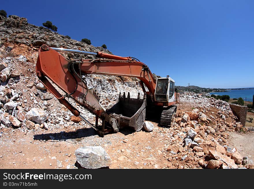 Excavator working on the slope of the quarry,fisheye. Excavator working on the slope of the quarry,fisheye