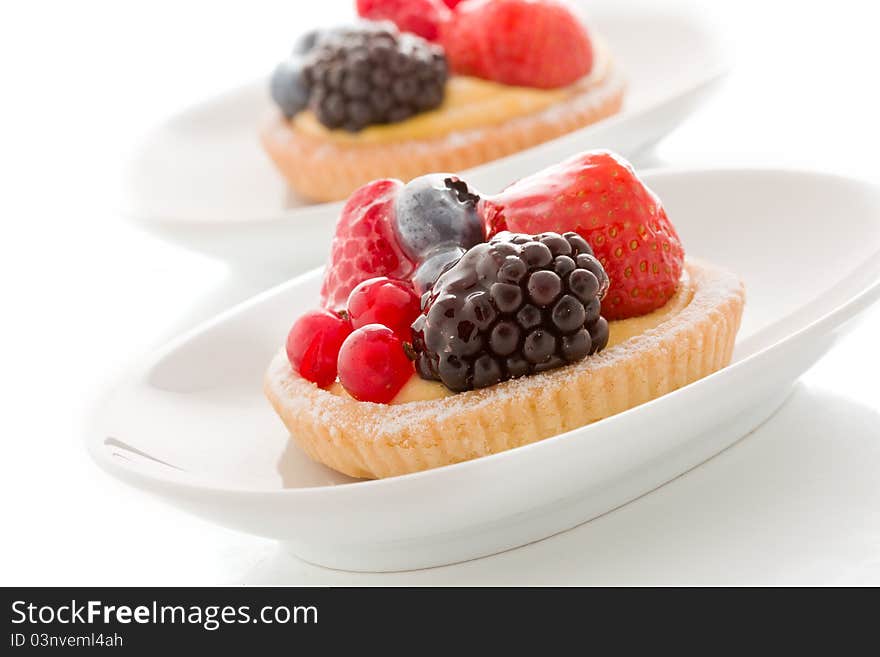 Pastry with berries on white background