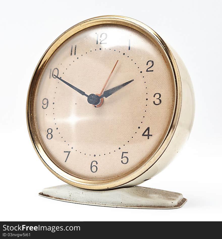 A vintage clock isolated on a white background. A vintage clock isolated on a white background