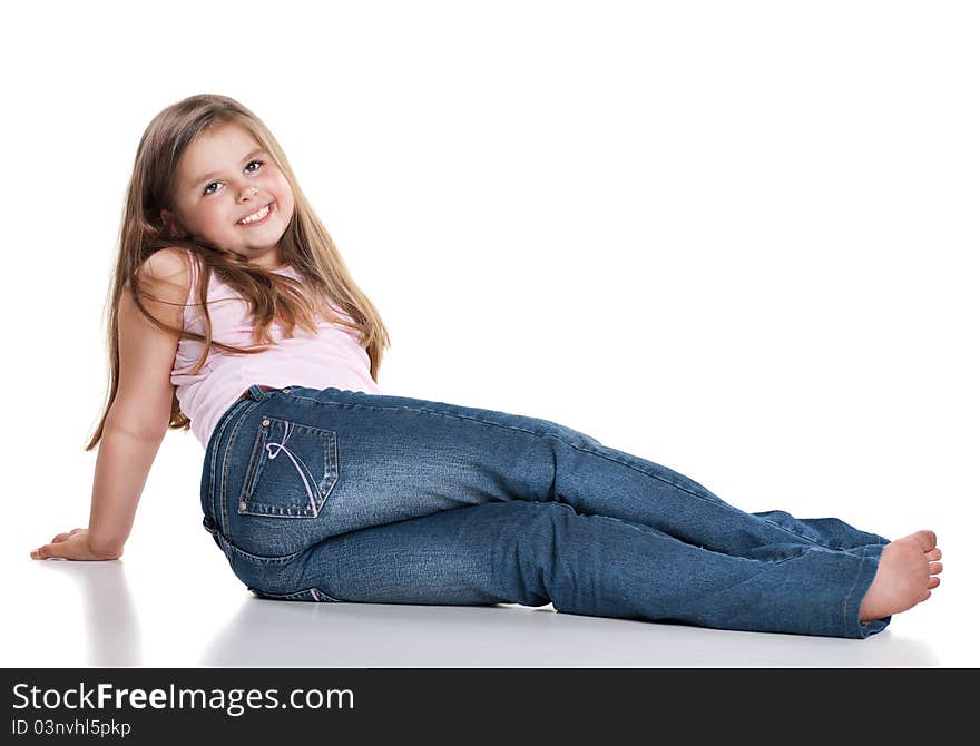 Cute happy little girl sitting on white background