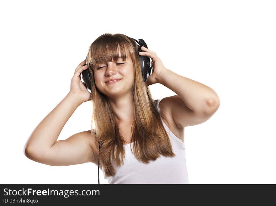 Lovely girl listening a music in headphones, white background