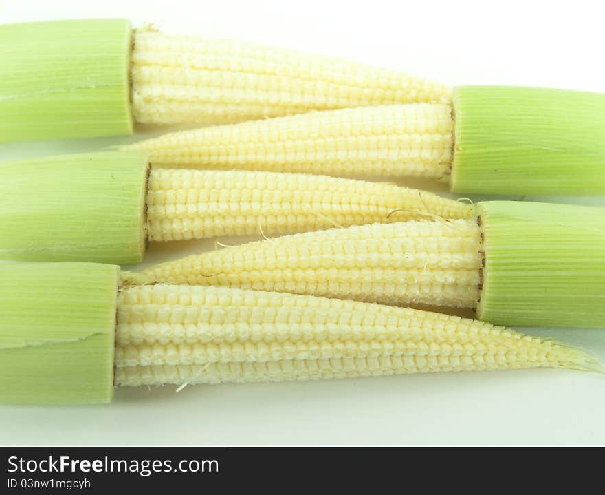 Baby corns on a white background put together. Baby corns on a white background put together.