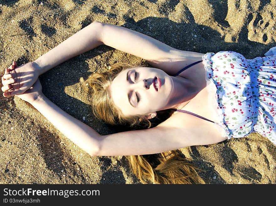 Young lady lying on the sand