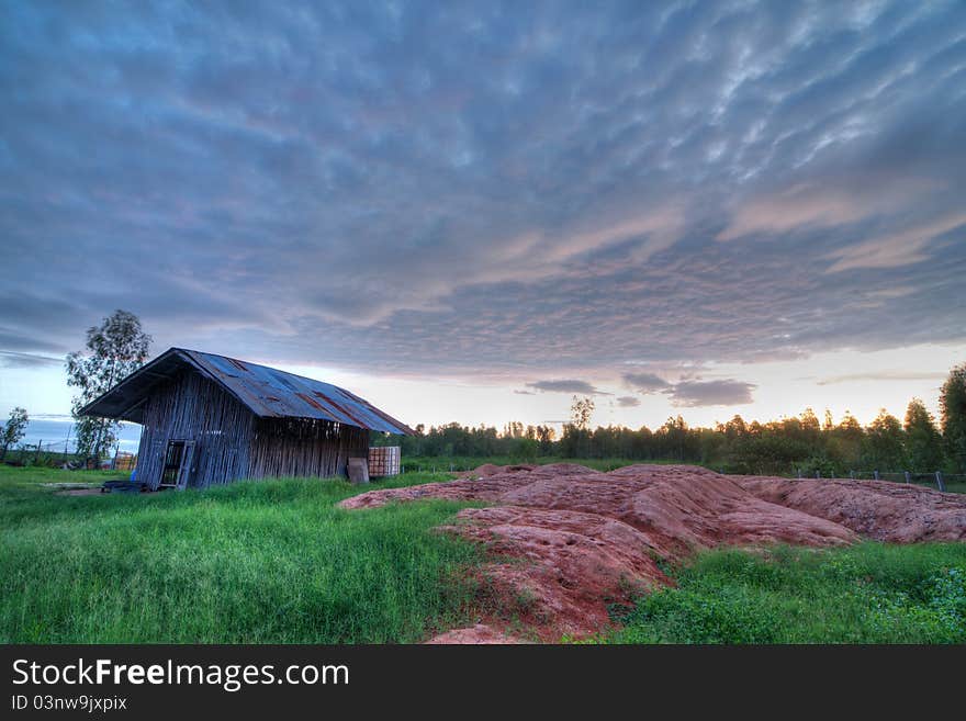 The wooden hut in the sunset time in this picture is in the rural area of northeastern thailand. It is used as the hen coop. The wooden hut in the sunset time in this picture is in the rural area of northeastern thailand. It is used as the hen coop.