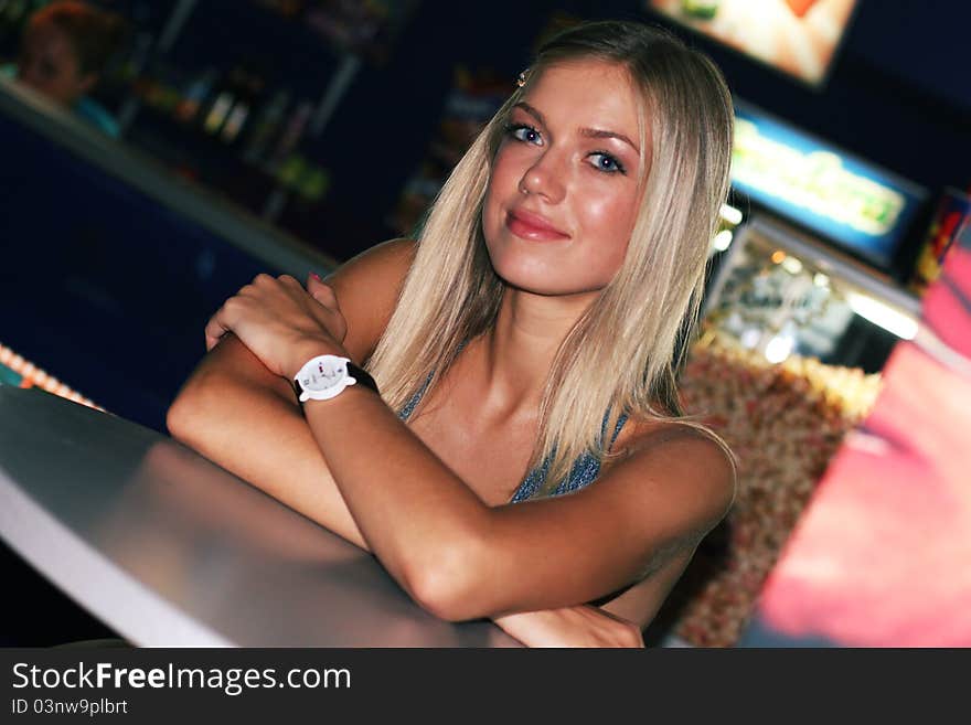 Young girl in cinema bar waiting for begining session