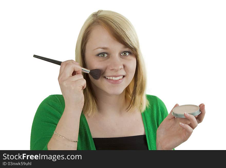 Attractive young woman applying blusher - isolated on white. Attractive young woman applying blusher - isolated on white