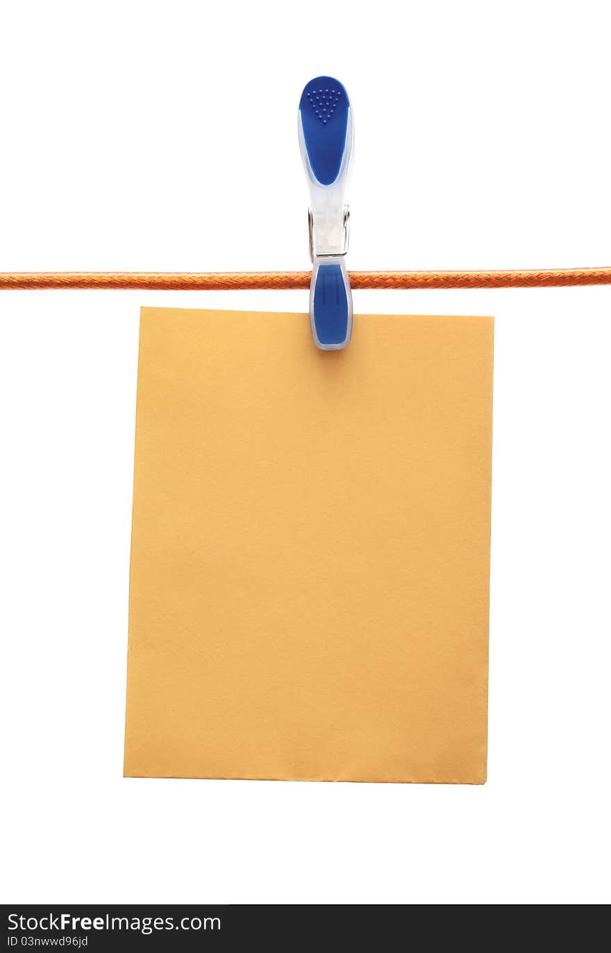 Cloth peg holding a paper sheet. Cloth peg holding a paper sheet