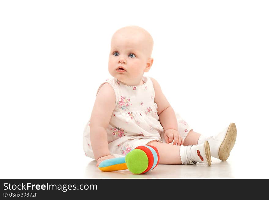 Pretty baby sitting and looking with interest on someting, isolated on white. Pretty baby sitting and looking with interest on someting, isolated on white