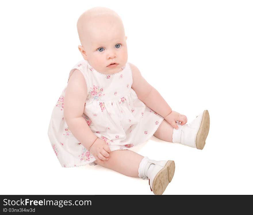 Pretty baby sitting and looking with interest on someting, isolated on white. Pretty baby sitting and looking with interest on someting, isolated on white