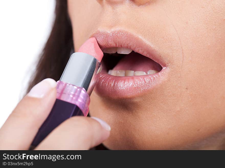 Woman applying lipstick