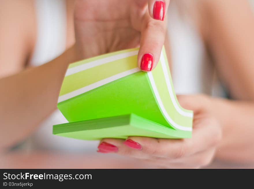 Women hands leaf through sticky leaves. Women hands leaf through sticky leaves