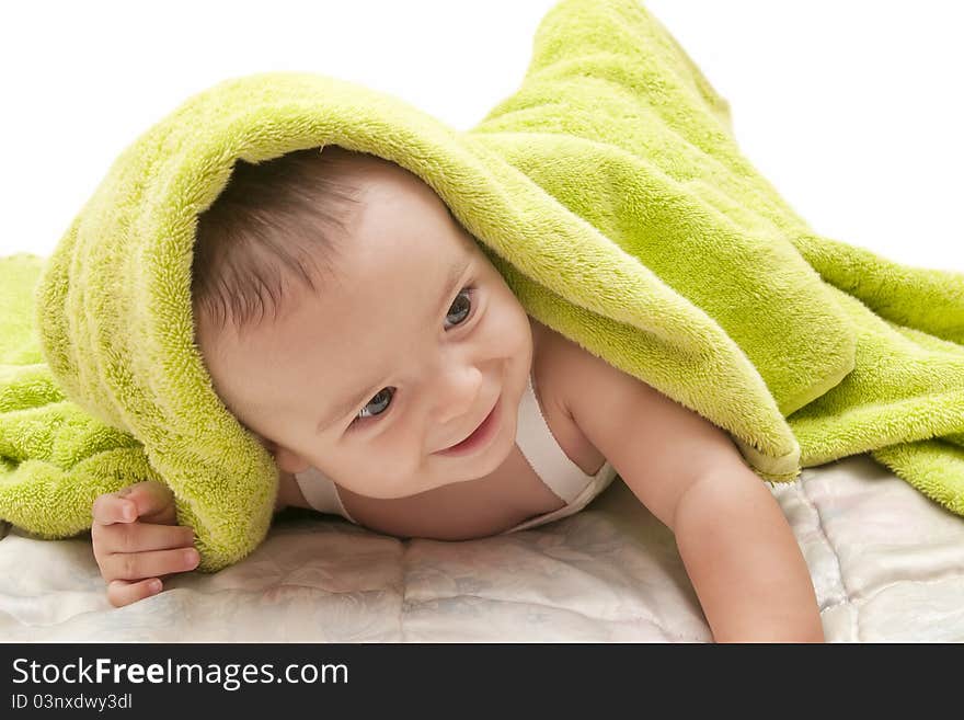 Beautiful baby with the green towel on white background. Beautiful baby with the green towel on white background