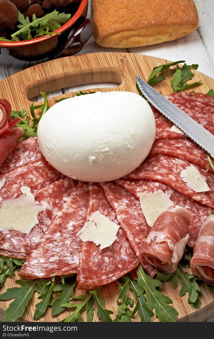 Italian bufala mozzarella with pepperoni on chopping board. Italian bufala mozzarella with pepperoni on chopping board