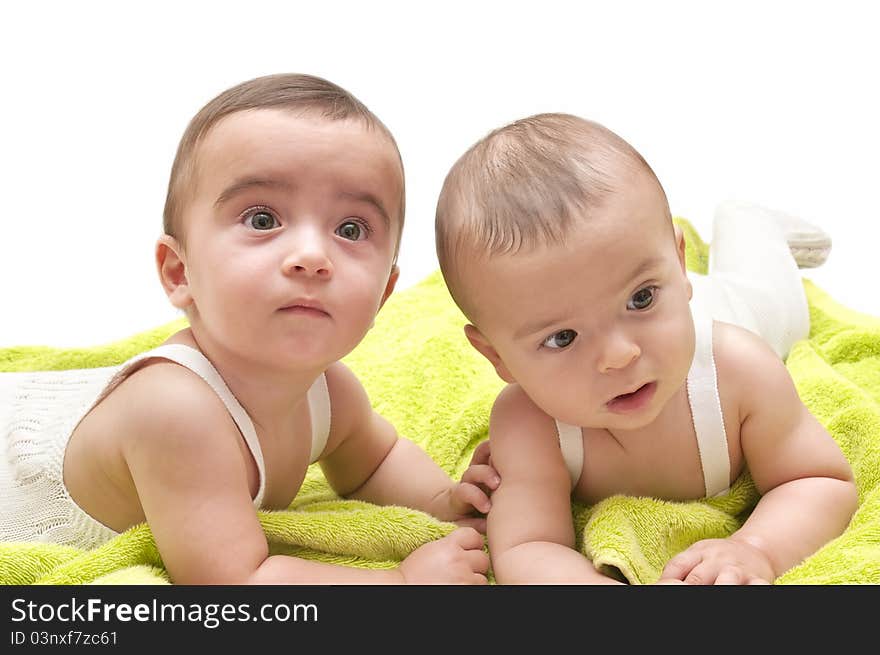 Beautiful babies with the green towel on white background. Beautiful babies with the green towel on white background