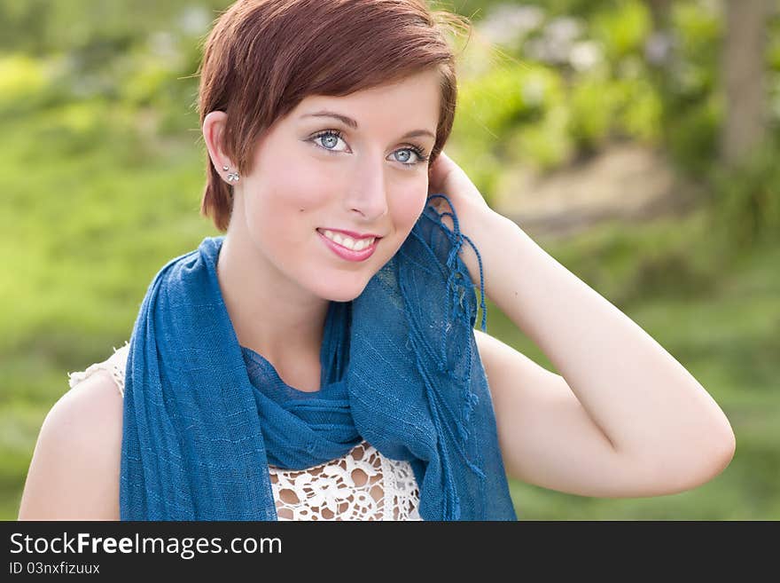 Outdoor Portrait of Pretty Blue Eyed Young Red Haired Adult Female with Blue Scarf. Outdoor Portrait of Pretty Blue Eyed Young Red Haired Adult Female with Blue Scarf.