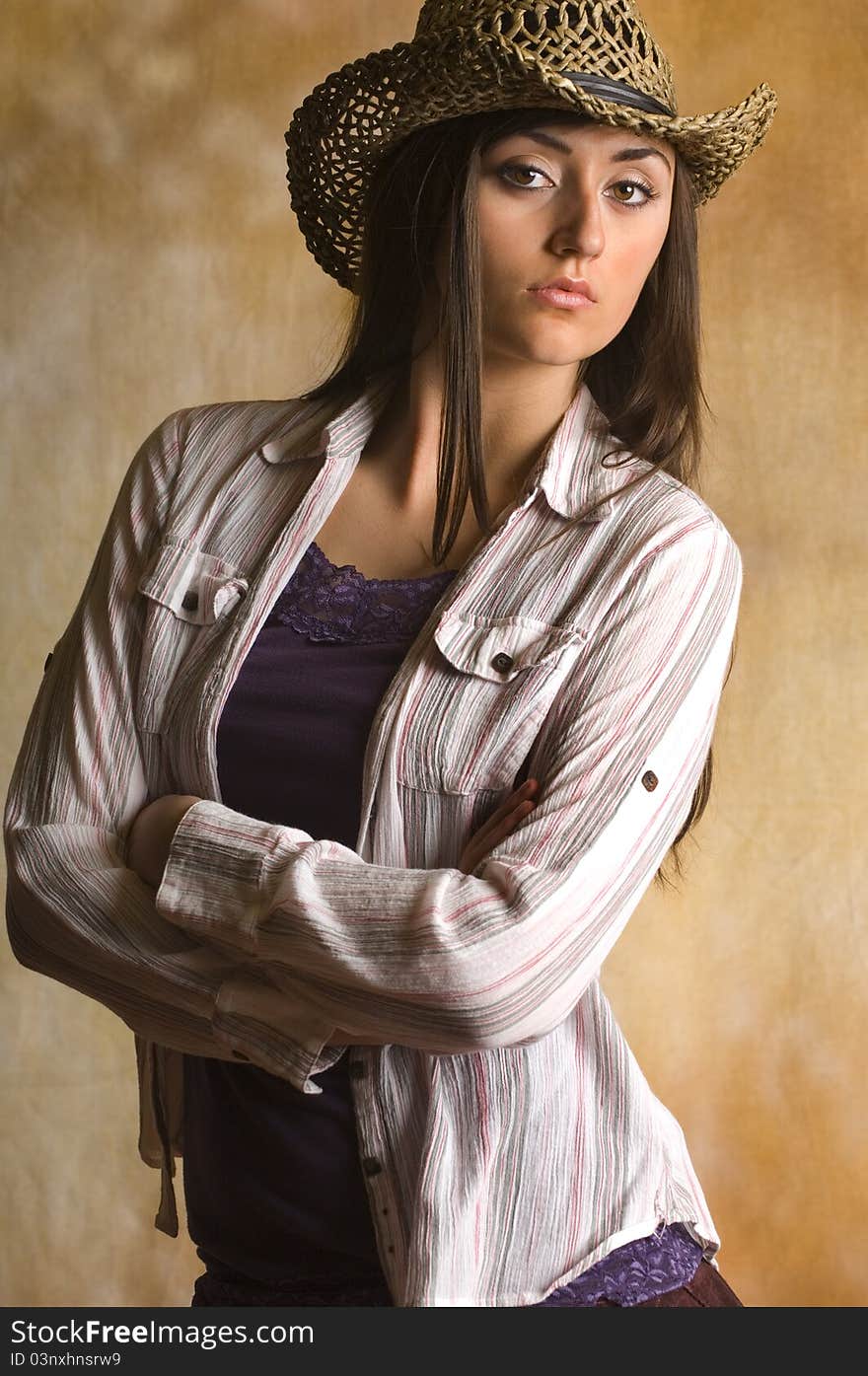 Teen cowgirl in tank top and Hat with long dark hair