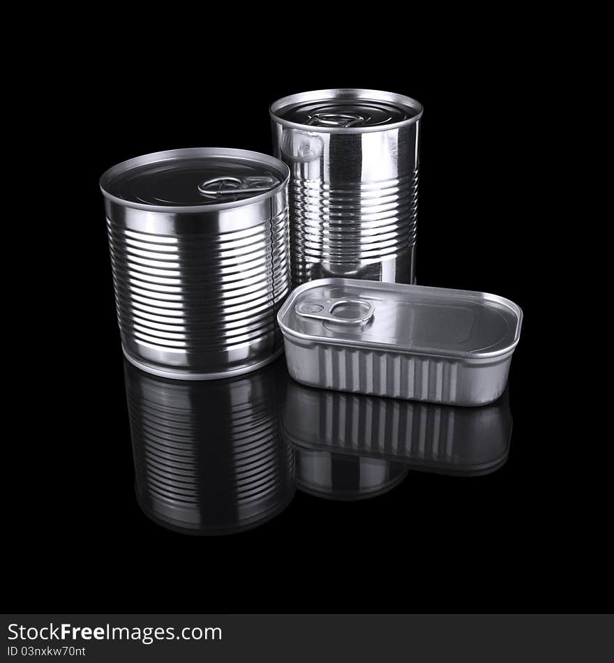 Three different tin cans isolated over a black background.