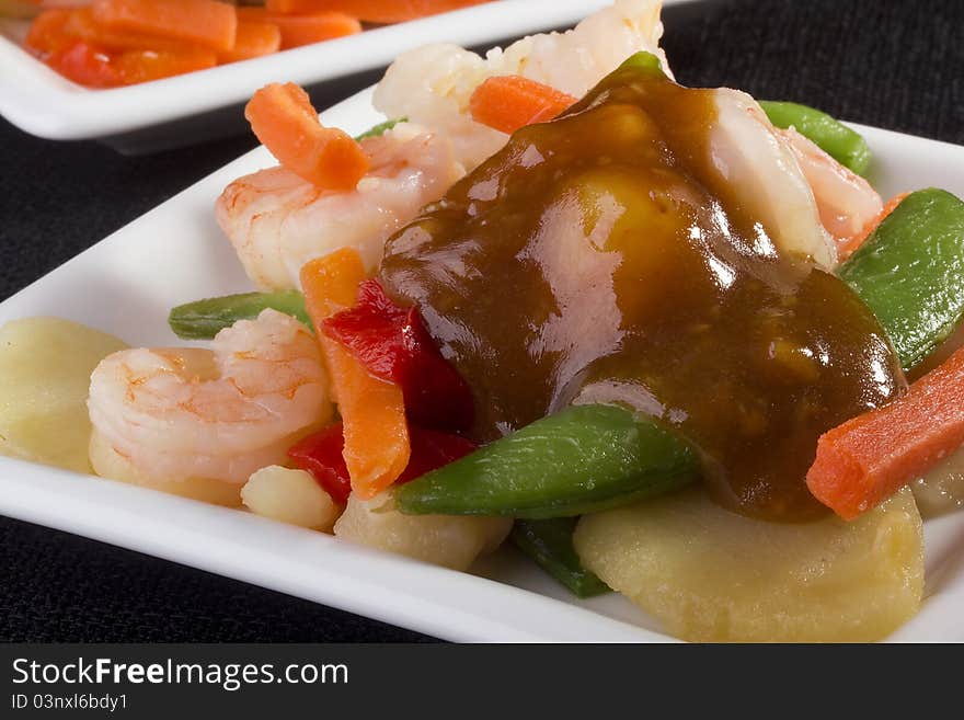 Close-up photograph of a shrimp salad on a white plate.