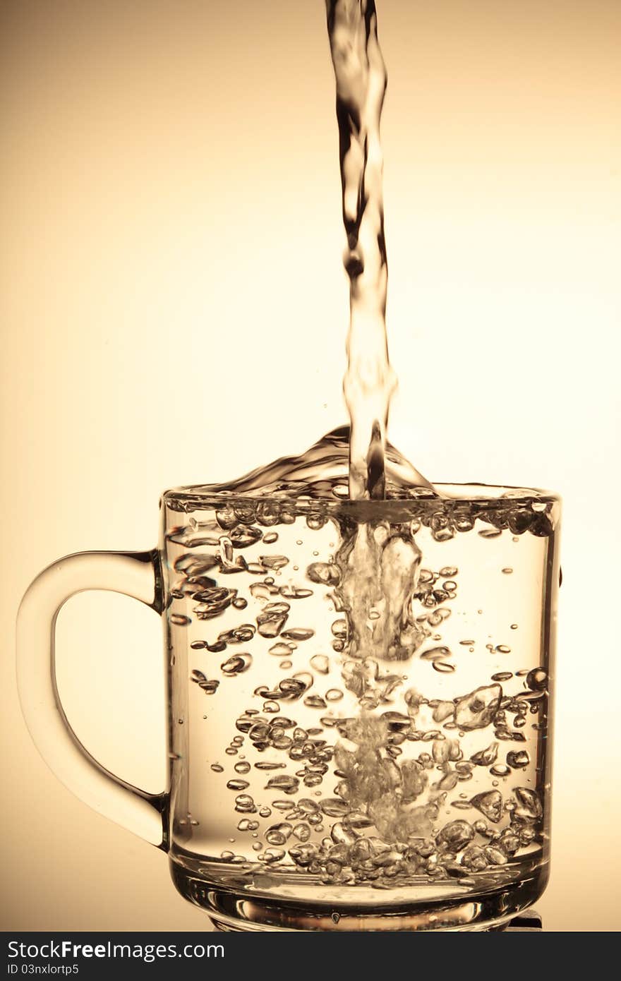 Water being poured into a glass. Water being poured into a glass.