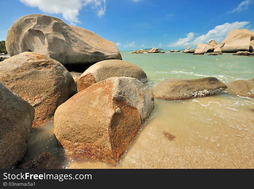 Sea beach coast full of rock under summer lighting, shown as featured sea coast physiognomy and different color in rock, sky and sea water. Sea beach coast full of rock under summer lighting, shown as featured sea coast physiognomy and different color in rock, sky and sea water.