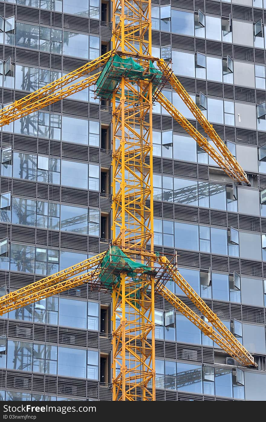 Modern buildings with external glass wall, under construction, shown as modern architecture construction and working place and equipment. Modern buildings with external glass wall, under construction, shown as modern architecture construction and working place and equipment.