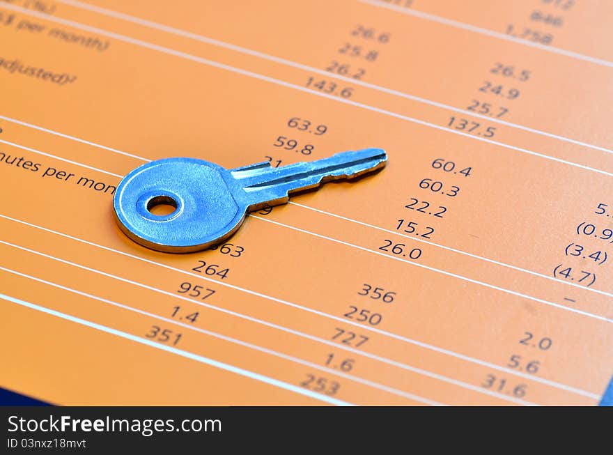 A key on top of a balance sheet. A key on top of a balance sheet.