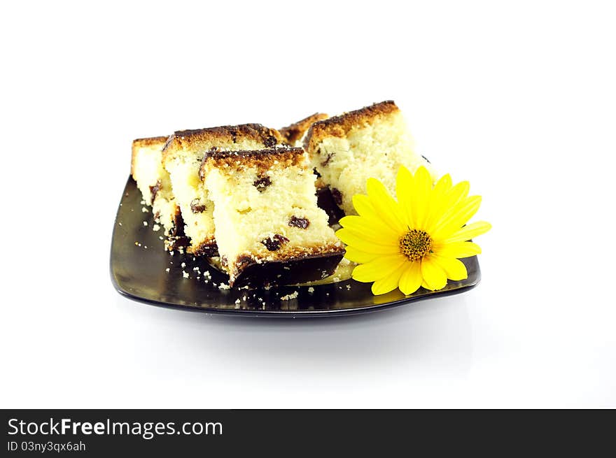 Sliced cake decorated with yellow flower on white background. Sliced cake decorated with yellow flower on white background