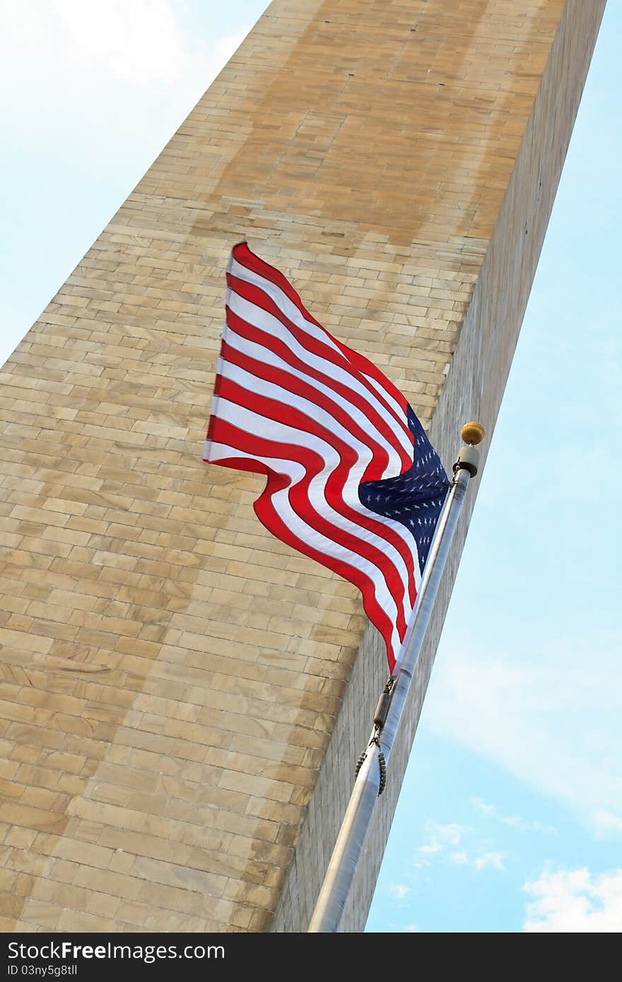 Washington D.C. monument with the American flag in the foreground. Washington D.C. monument with the American flag in the foreground.