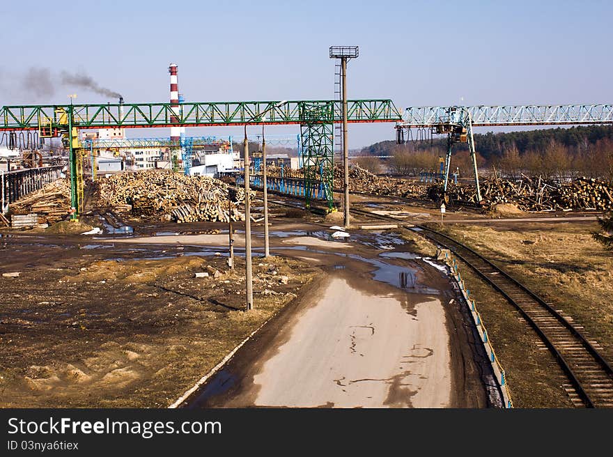 Logs lying on the earth in factory territory on a woodworking (in a spring season). Logs lying on the earth in factory territory on a woodworking (in a spring season)