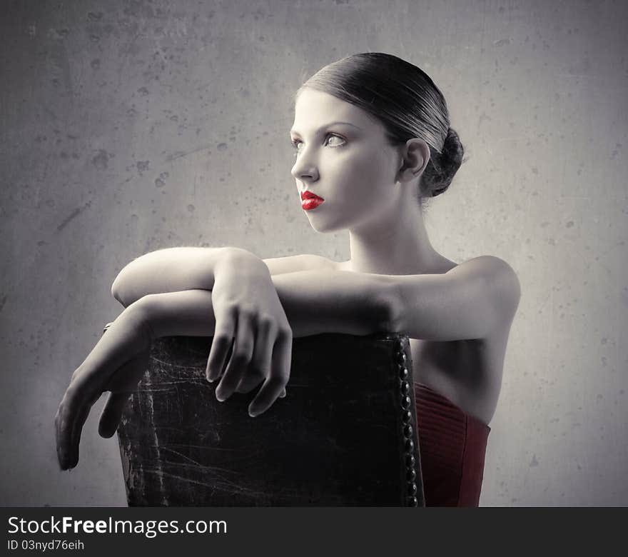 Beautiful woman sitting on an old chair. Beautiful woman sitting on an old chair