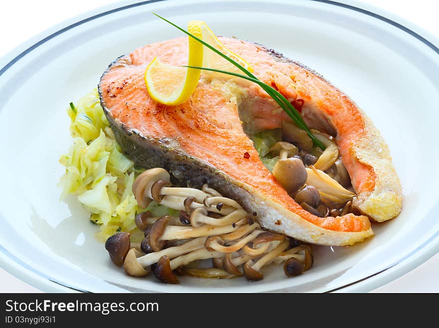 Salmon, grilled with mushrooms and cabbage in the