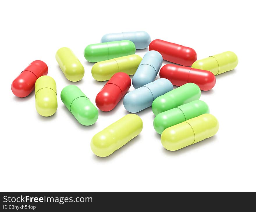 Many colored pills on white background