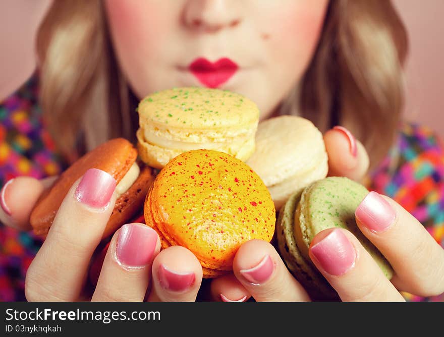 A young woman loves her sweet macaron. A young woman loves her sweet macaron.