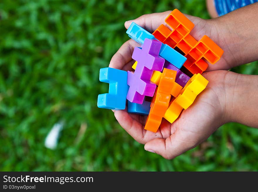 The boy holding plastic toy block