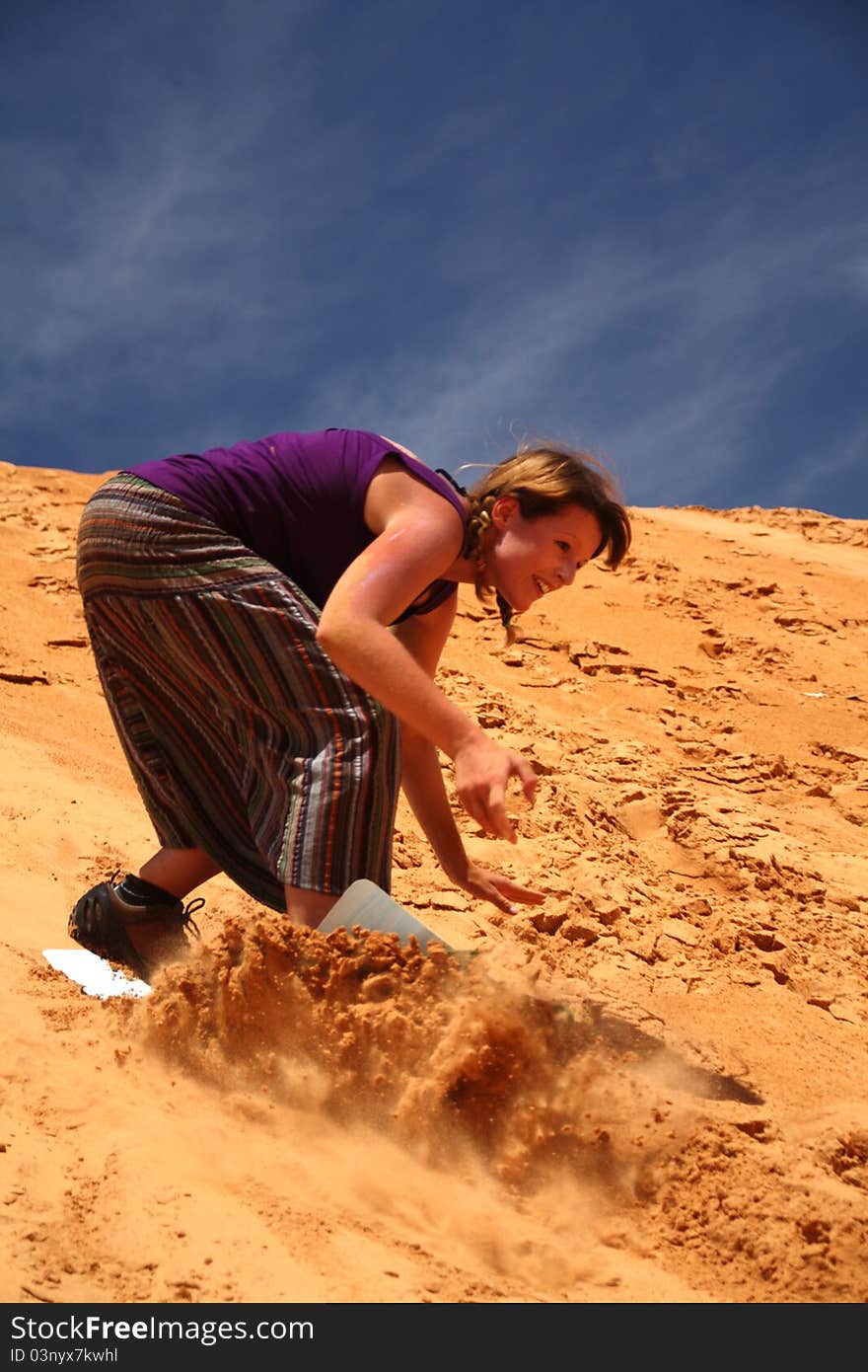 Woman boarding on sand dunne in Mui Ne - Viet - Nam. Woman boarding on sand dunne in Mui Ne - Viet - Nam