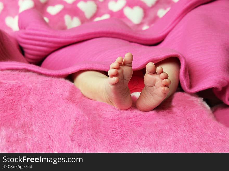 Newborn baby clutching mothers finger