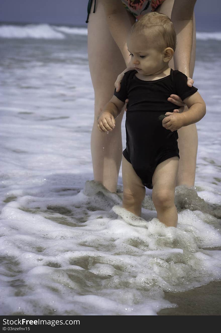 A young toddler (15 mo.) playing at the beach for the first time. A young toddler (15 mo.) playing at the beach for the first time.