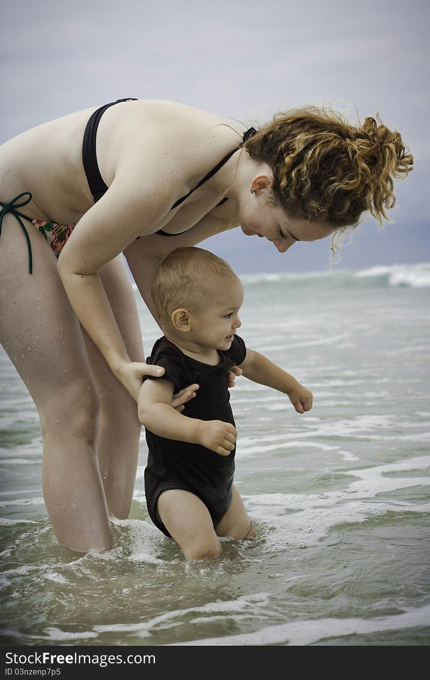 A toddler exploring the beach for the first time. A toddler exploring the beach for the first time