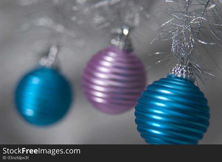 Three hanging metallic christmas ornaments